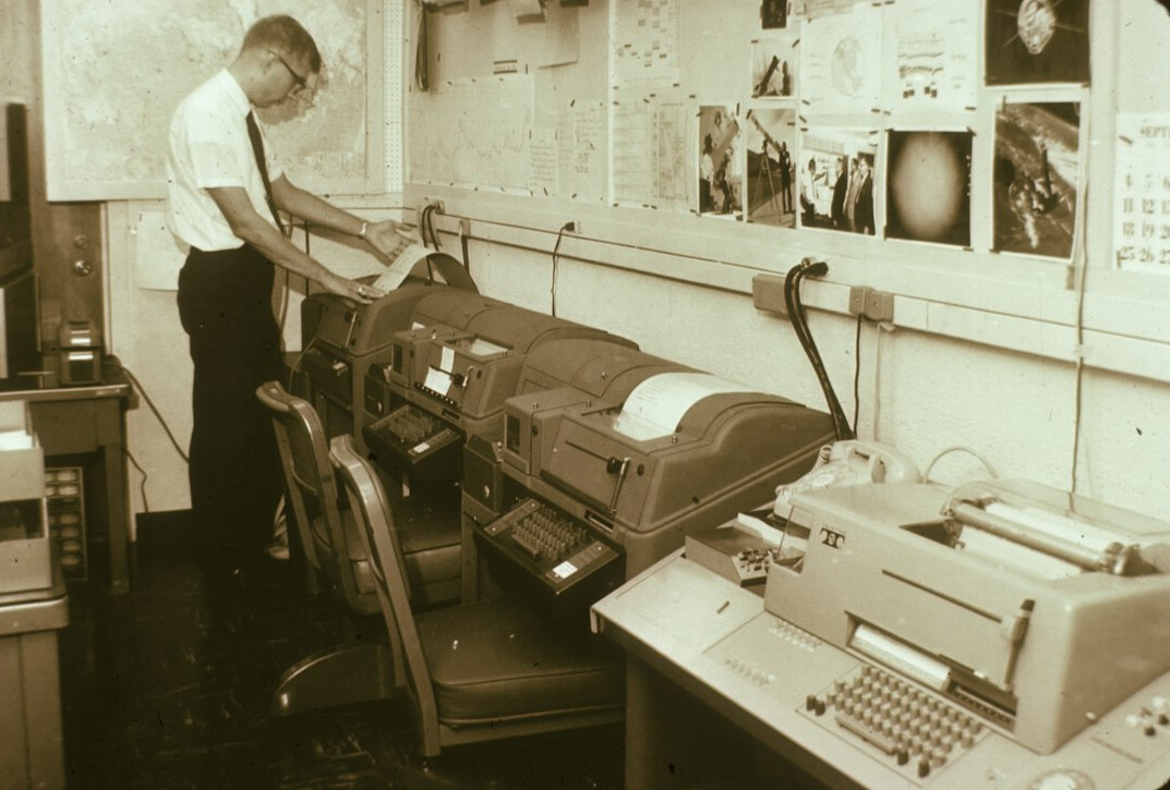 Broadcast control room operator wearing a headset at a desk