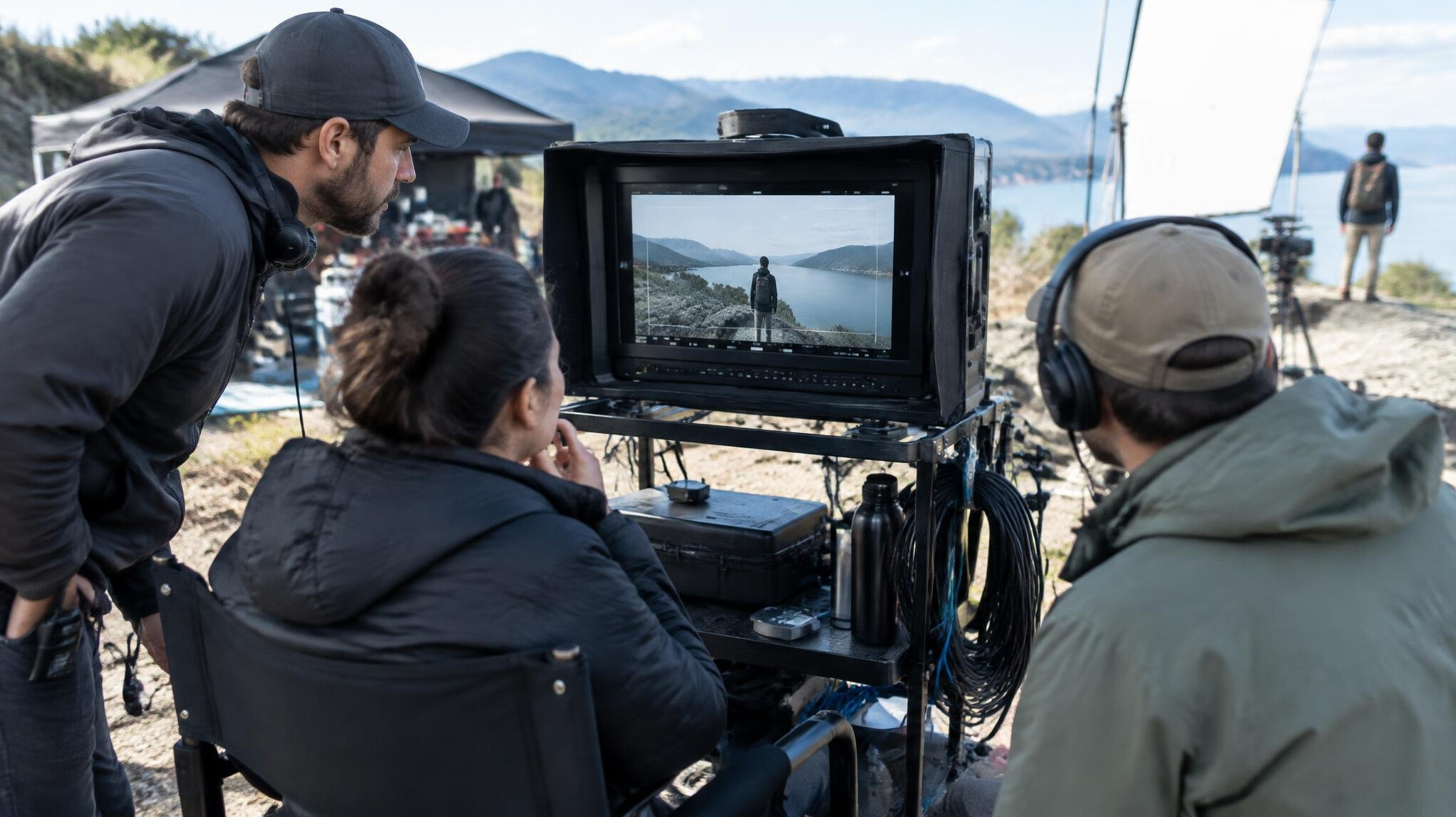 Production crew reviewing footage on a monitor during a live shoot